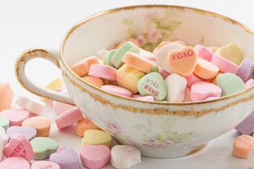 Valentine conversation hearts in a vintage teacup