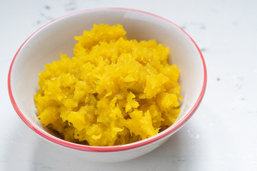 Pumpkin mash in bowl on wooden table