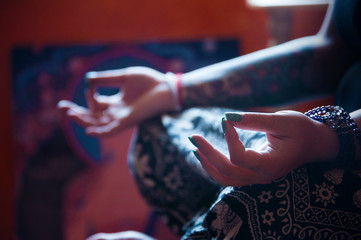 Meditating woman inside a beautiful global spirit style bedroom.  