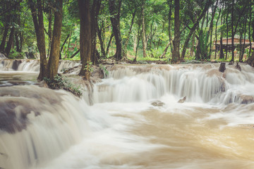 View of Kroeng Krawia Waterfall around with green forest in Sangkhlaburi, Kanjanaburi, Thailand.