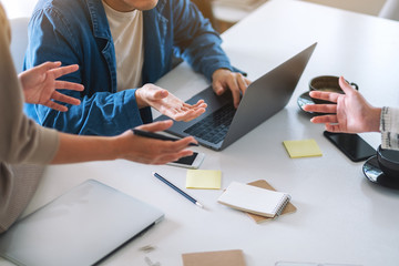Group of businessman discussing and working on laptop computer on the table in office