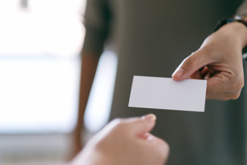 Businessman holding and giving empty business card