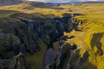 Fototapeta na wymiar The most picturesque canyon Fjadrargljufur and the shallow creek, which flows along the bottom of the canyon. Fantastic country Iceland. September 2019. aerial drone shot