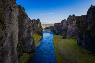 Fototapeta na wymiar The most picturesque canyon Fjadrargljufur and the shallow creek, which flows along the bottom of the canyon. Fantastic country Iceland. September 2019. aerial drone shot