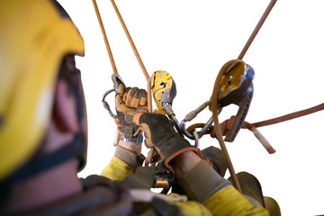 Defocused of rope access miner worker wearing safety fall protection helmet working at height...