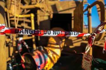 Danger red and white tape barricade  exclusion area at confined space entry door authorised personnel only at construction site Sydney city, Australia   