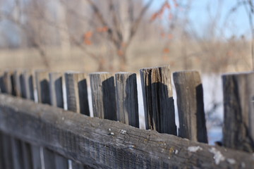 Wooden fence in the winter in the village. Winter landscape