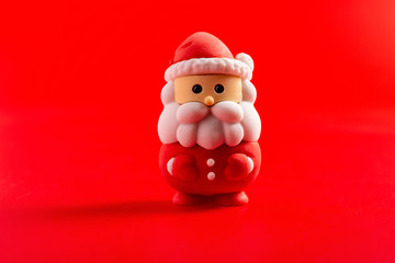 christmas decorative doll of santa claus on red background