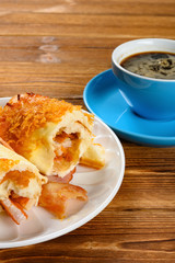 side view cut out bread with bacon and shredded pork and cup of coffee vertical composition