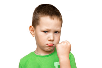 little angry boy threatening shows fist. relationship problems of children and parents. child psychology concept