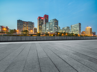 Fototapeta na wymiar Empty city square road and modern business district office buildings in Beijing at night, China