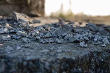 Close-up of pieces of crumbling abandoned building. Small pieces of cement on stone floor. Abstract...
