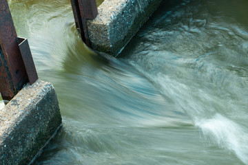 The water flows through the floodgates in the irrigation canals.