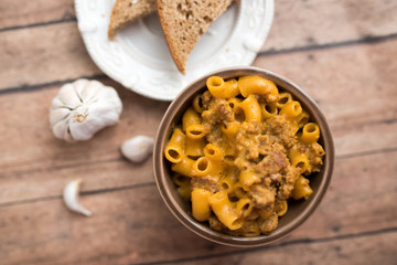 Homemade Cheeseburger Macaroni and cheese served in a small brown bowl made with ground turkey