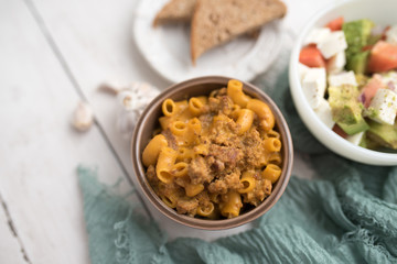 Homemade Cheeseburger Macaroni and cheese served in a small brown bowl made with ground turkey
