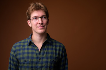 Fototapeta premium Face of young handsome hipster man with eyeglasses