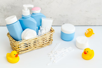 Baby bathroom cosmetics near pacifier and rubber duck on white background