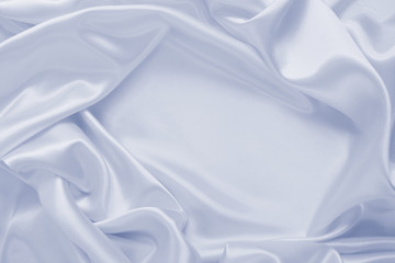 Delicate satin draped fabric of blue color texture for festive backgrounds