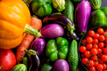 Harvest autumn vegetables, top view, close-up. Pumpkin over onions, carrots, eggplant, tomatoes, paprika, garlic, cucumbers. Organic food background. Thanksgiving day concept.
