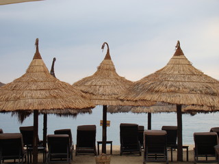 Banana leaf umbrellas and chairs on the beach