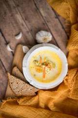 broccoli cheese soup served with toasted bread in a bowl