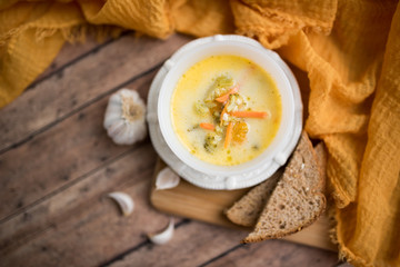 broccoli cheese soup served with toasted bread in a bowl