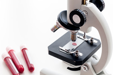 Blood testing. Samples viewing under microscope on white background top view copy space