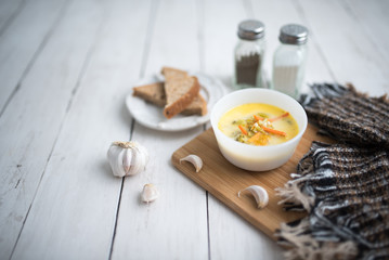 broccoli cheese soup served with toasted bread in a bowl