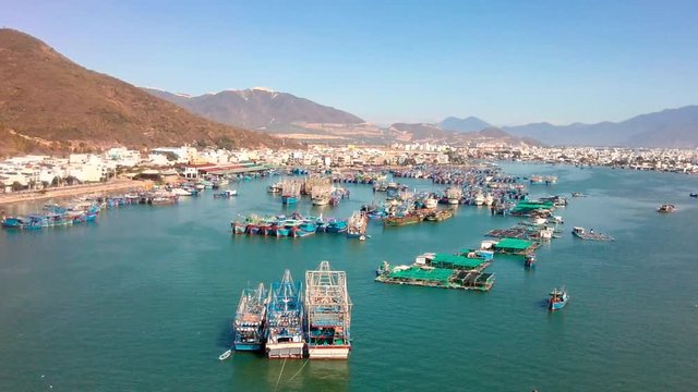 Nha Trang harbor and fishing village aerial view densely populated with wooden fisherman boats establishing shot  Khanh Hoa province Vietnam