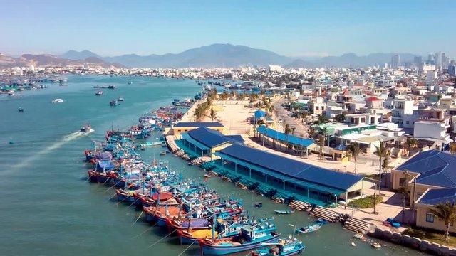 Nha Trang harbor and fishing village aerial view densely populated with wooden fisherman boats establishing shot  Khanh Hoa province Vietnam