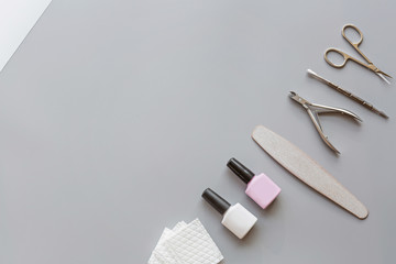 Stylish trendy manicure accessories with gel nail polishes, scissors, cuticle pusher, cotton pad....
