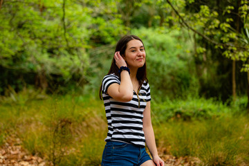 Fototapeta premium Young woman walking in the parkland 