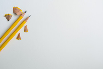 Yellow pencil on a white drawing parer background ,creative innovation idea symbol or education concept