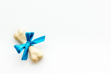 Small present for dogs. Chewing bones with bow on white background top view space for text