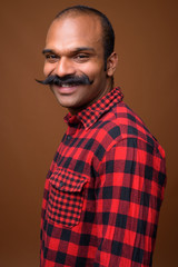 Portrait of happy Indian hipster man with mustache