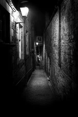 Acrylic prints Narrow Alley A dark creepy narrow European alley at night, surrounded by bricks and cobblestone. Illuminated only with some street lamps. Concept of scared or being alone and frightened