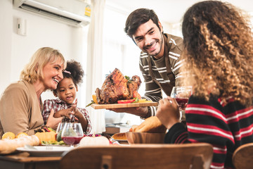 Thanksgiving Celebration Tradition Family Dinner Concept.family having holiday dinner and cutting...