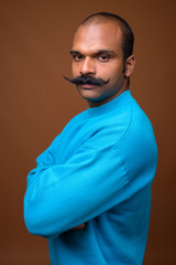 Obraz premium Portrait of Indian man with mustache wearing blue sweater
