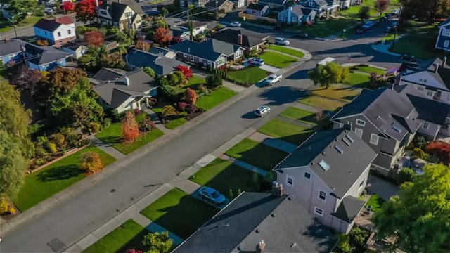 Flying over a small town suburban neighborhood on a sunny day