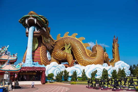 Suphan Buri, Thailand - October 27, 2019: the landmark for Buddhist with gold huge dragon to be worship. Tourists come to visit because they believe in dragon in zodiac at Suphan Buri, Thailand