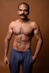 Portrait of muscular Indian man with mustache shirtless