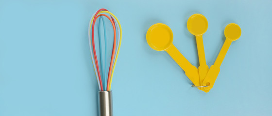 close up of baking utensils tools and cooking concept on blue background