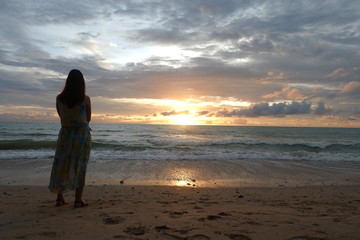 Fototapeta na wymiar woman on the beach at sunset