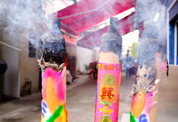 Very Big red incense sticks burning on street,the Chinese on the incense means is auspicious and thriving