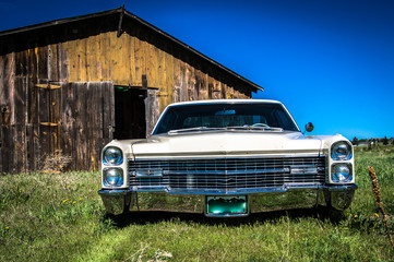 Lowered car in field with barn near elizabeth colorado