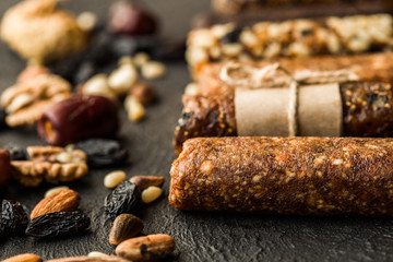 Bunch of mixed gluten free energy bars with dried fruit & various nuts, wooden background. Healthy vegan super food, different fitness diet snacks for sporty lifestyle. Top view, copy space.
