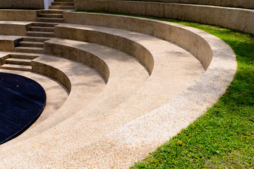the steps of the outdoor grass seating in park view - obrazy, fototapety, plakaty
