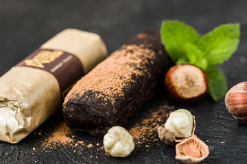 chocolate hazelnut  bars with dried fruit & various nuts, wooden background. Healthy vegan super food, different fitness diet snacks for sporty lifestyle. Top view, copy space.