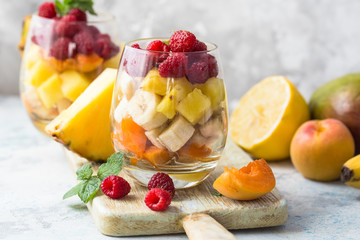 Fresh healthy fruit salad. Selective focus. Natural eating. Fruit salad on white background - diet, healthy breakfast. Healthy food dinner table. Gourmet food. Copy space. Tropical fruit.