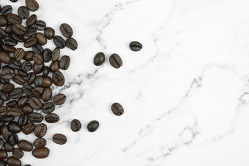 Coffee beans on a marble pattern background. With copy space